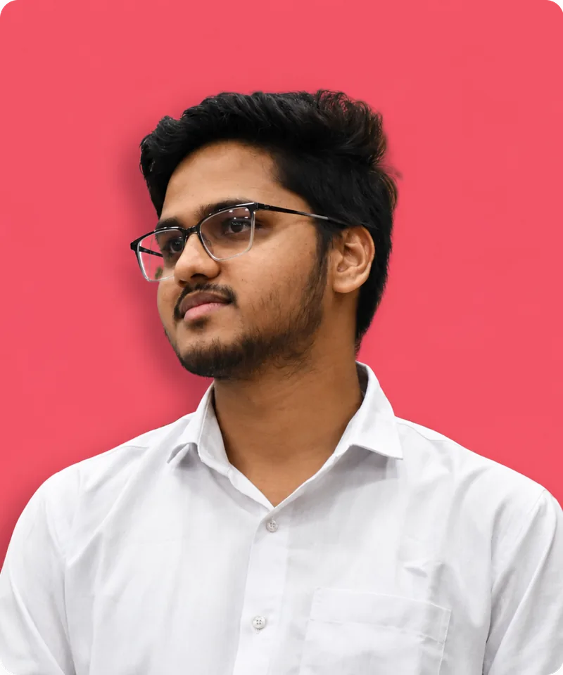Portrait of Yuvraj Gupta in a white shirt against a pink background